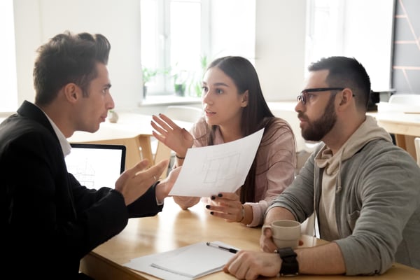 Angry couple disputing about mortgage or construction with lawyer