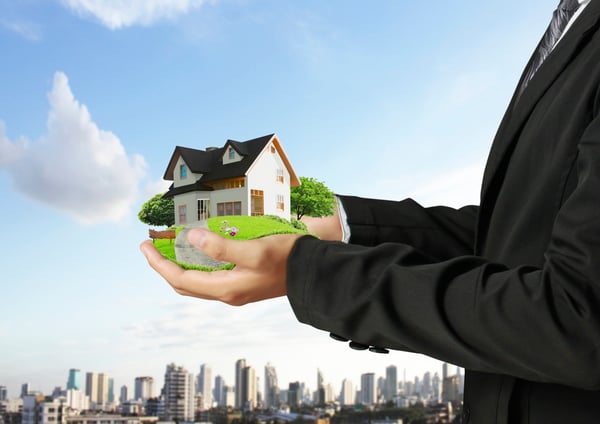 Increase Investment Portfolio, male holding a house in his hands