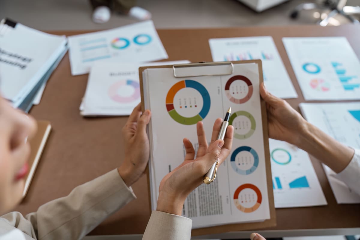 Two professionals reviewing charts and graphs