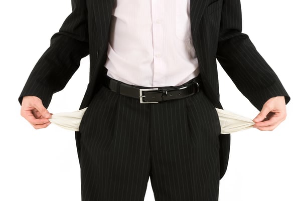 A man in a suit with pockets pulled out, indicating he has no money