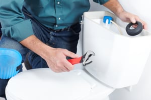 Man fixing the toilet