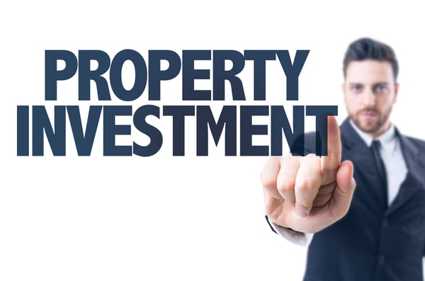 A man is pointing to the words 'property investment'