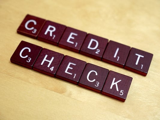 credit check spelled in scrabble tiles