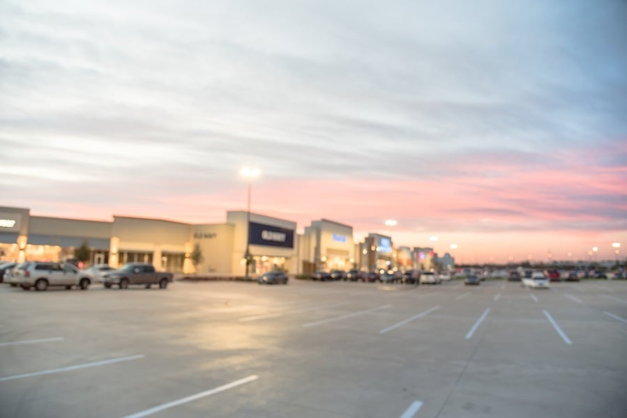 Blurred image exterior view of empty parking lots in modern shopping center