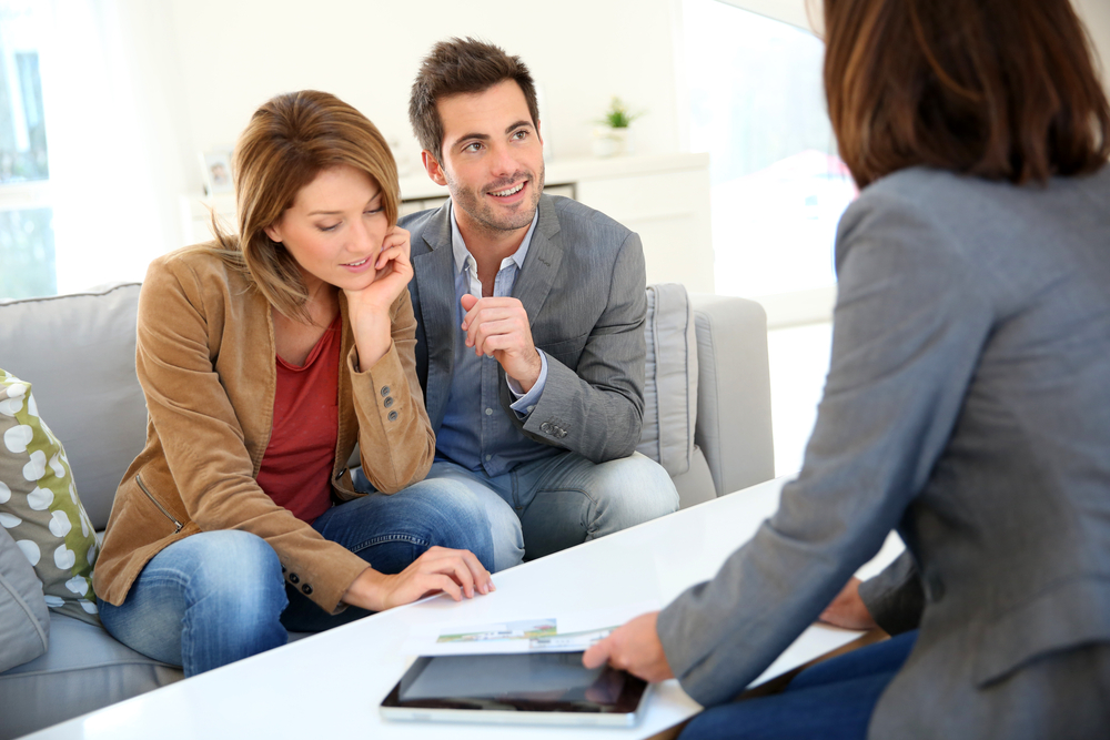 Couple meeting financial adviser for real estate project