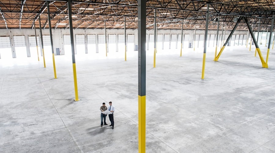 Team of people checking out the new interior of an empty warehouse space