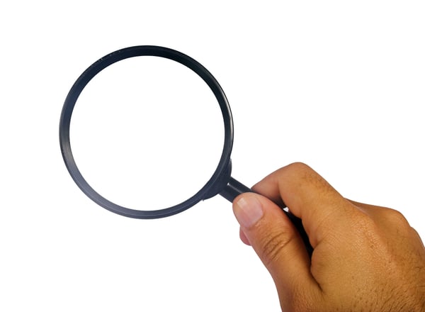 hand holding a magnifying glass