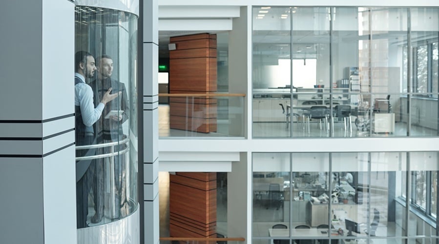 office workers having talk in elevator