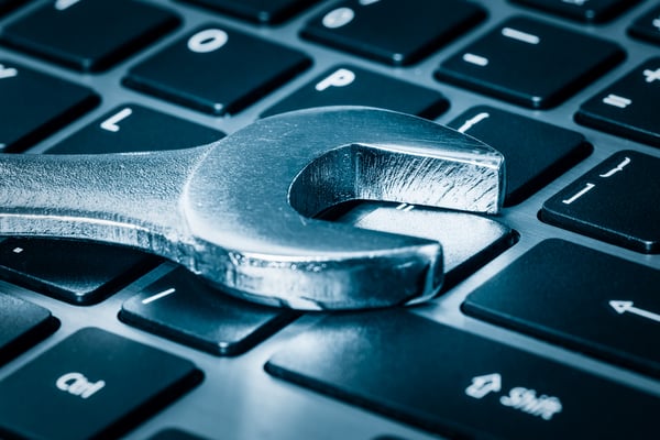 property management, wrench on laptop keyboard