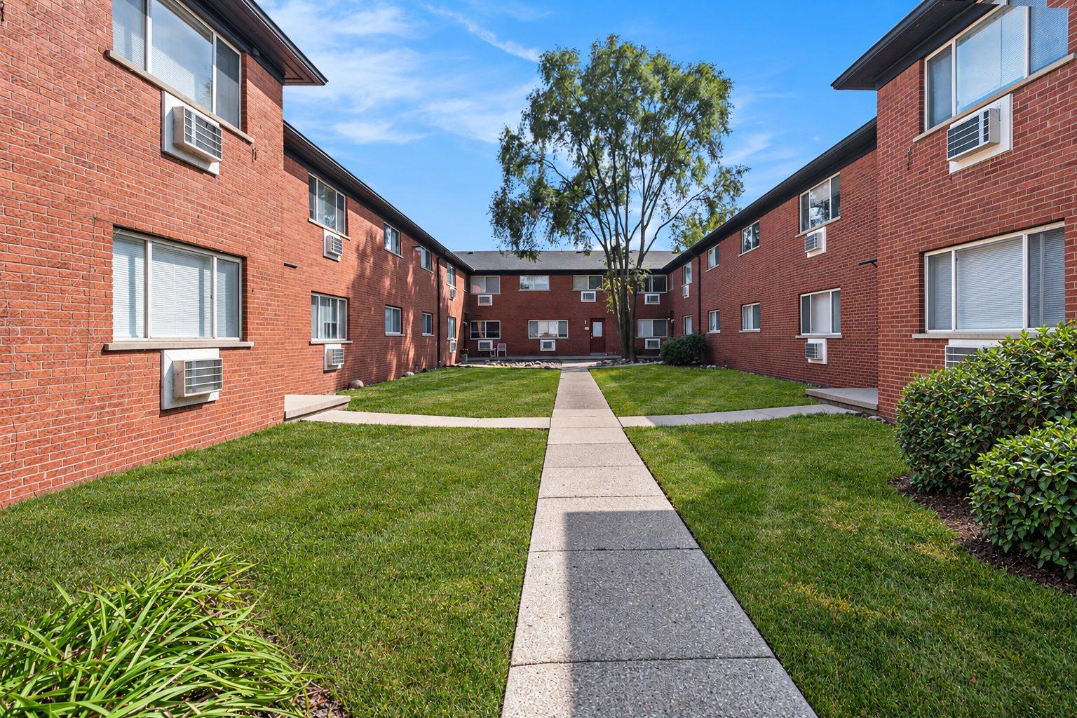 Landscaped courtyard between the brick wings of 629 W. Maple