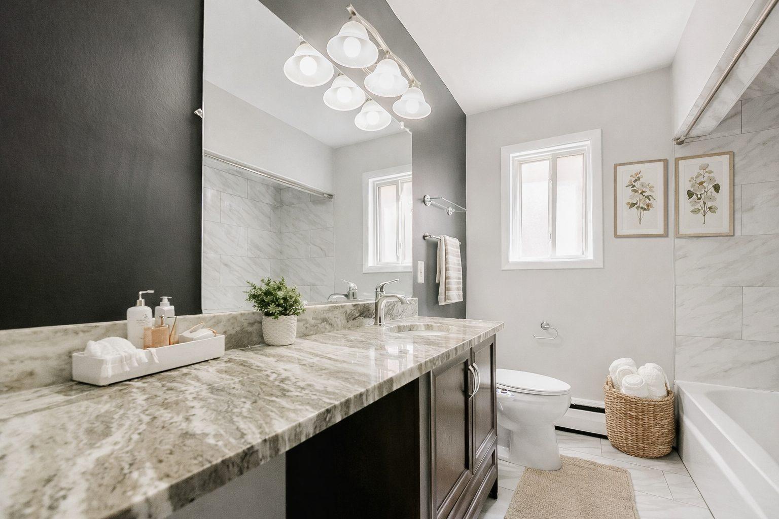 Updated bathroom with a granite vanity