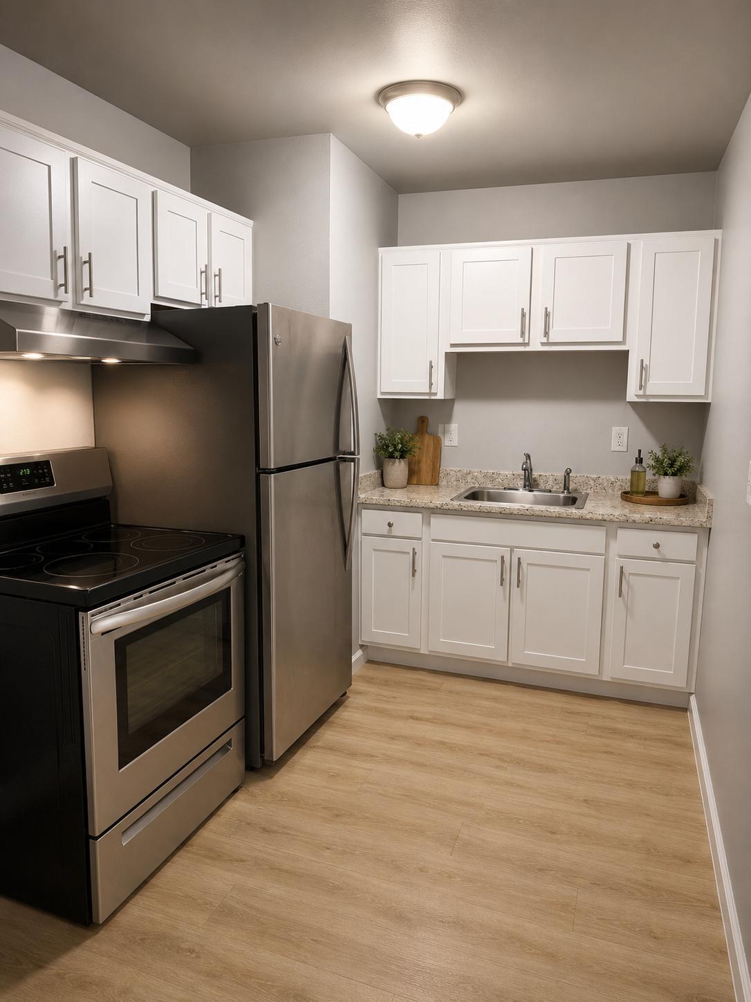 Kitchen with white shaker cabinets, granite-look counters and a stainless steel range and refrigerator